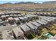 A landscape aerial view showcasing the neighborhood's homes, street layout and mountain backdrop at 12525 Lylan Ridge St, Las Vegas, NV 89138