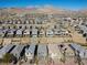Expansive aerial view of a community showcasing homes, desert landscaping, and mountain views at 12525 Lylan Ridge St, Las Vegas, NV 89138