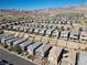 A large community of homes with landscaping, walls, and mountain views from an aerial perspective at 12525 Lylan Ridge St, Las Vegas, NV 89138
