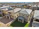 Aerial view of the backyard with artificial turf, small patio, with neighboring homes and mountain views at 12525 Lylan Ridge St, Las Vegas, NV 89138