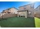 Backyard features an artificial lawn and a partially covered patio at 12525 Lylan Ridge St, Las Vegas, NV 89138