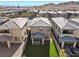 An aerial view of the home's backyard with artificial turf, a small patio and neighboring houses at 12525 Lylan Ridge St, Las Vegas, NV 89138