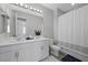 Bathroom featuring a double sink vanity, large mirror, and shower with a shower curtain at 12525 Lylan Ridge St, Las Vegas, NV 89138