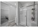 Bright bathroom featuring a glass-enclosed shower with built-in shelving and a view to the bedroom at 12525 Lylan Ridge St, Las Vegas, NV 89138