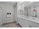 Modern bathroom featuring double sinks, a large mirror, and a separate shower area at 12525 Lylan Ridge St, Las Vegas, NV 89138