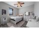 Bedroom with a large window, wood-look floors, ceiling fan and neutral décor at 12525 Lylan Ridge St, Las Vegas, NV 89138