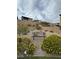 Community outdoor area with rock beds, greenery, and a bench providing relaxing common space at 12525 Lylan Ridge St, Las Vegas, NV 89138