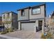 Charming two-story home with neutral colors, attached garage, and patterned brick driveway at 12525 Lylan Ridge St, Las Vegas, NV 89138