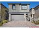 Two-story home with a gray exterior, a two-car garage, and well-maintained landscaping at 12525 Lylan Ridge St, Las Vegas, NV 89138