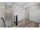 Hallway with wood-look floors, white closet, and railing on the stairs at 12525 Lylan Ridge St, Las Vegas, NV 89138