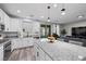 Modern kitchen featuring stainless steel appliances, white cabinets, granite countertops and an island with seating at 12525 Lylan Ridge St, Las Vegas, NV 89138