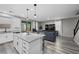 Open-concept living room with island, stainless appliances, granite countertops, and a view of the outdoor space at 12525 Lylan Ridge St, Las Vegas, NV 89138