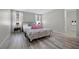 A serene main bedroom with stylish furnishings, neutral tones, and a view into the bathroom at 12525 Lylan Ridge St, Las Vegas, NV 89138