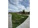 Open community park with green grass and paved walkways leading to a covered picnic structure at 12525 Lylan Ridge St, Las Vegas, NV 89138