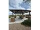 Covered picnic area with stone pillar details, featuring tables and a paved base, creating outdoor space at 12525 Lylan Ridge St, Las Vegas, NV 89138