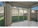 Enclosed sunroom with wood look flooring and walls of windows leading to backyard at 12525 Lylan Ridge St, Las Vegas, NV 89138