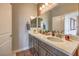 Bathroom featuring double sinks, granite countertops, modern fixtures, and a well-lit vanity area at 1918 Molly Brook Dr # Lot 5, North Las Vegas, NV 89084