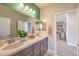 Bathroom featuring double sinks, modern vanity, quartz counters, and a view into the bedroom at 1918 Molly Brook Dr # Lot 5, North Las Vegas, NV 89084