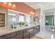 Bright bathroom featuring double sinks, modern vanity, quartz counters, and large mirror at 1918 Molly Brook Dr # Lot 5, North Las Vegas, NV 89084