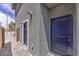 Exterior corner featuring two stylish, modern blue doors, and neutral stucco at 1918 Molly Brook Dr # Lot 5, North Las Vegas, NV 89084