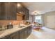 Contemporary kitchen featuring dark cabinets, white countertops, and an open layout connecting to the living room at 1918 Molly Brook Dr # Lot 5, North Las Vegas, NV 89084