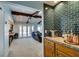 Modern wet bar featuring striking blue backsplash and wood cabinets at 2246 Almart Cir, Henderson, NV 89014