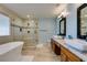 Bright bathroom showcasing double sinks, a soaking tub, and walk-in shower, designed for relaxation at 2246 Almart Cir, Henderson, NV 89014