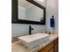 Bathroom featuring a granite countertop, custom faucet, wood cabinetry, and a modern rectangular sink at 2246 Almart Cir, Henderson, NV 89014