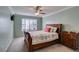 Bedroom with standard ceilings, a ceiling fan, window with shutters, and a bed covered with a quilt at 2246 Almart Cir, Henderson, NV 89014