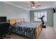 Bedroom with standard ceilings, a ceiling fan, window with shutters, and a bed covered with a quilt at 2246 Almart Cir, Henderson, NV 89014