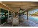 Inviting covered patio with ceiling fans and stone flooring, perfect for outdoor living at 2246 Almart Cir, Henderson, NV 89014