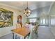 Open dining room with light green walls, wood table and view to living room at 2246 Almart Cir, Henderson, NV 89014