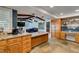 Kitchen with granite countertops, stone flooring, wood cabinets, and an open layout to the living room at 2246 Almart Cir, Henderson, NV 89014