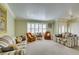 Bright living room featuring a bay window, neutral carpet, and comfortable seating, perfect for Gathering gatherings at 2246 Almart Cir, Henderson, NV 89014