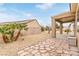 Backyard view of covered patio and rock landscaping with desert plants at 2404 Garganey Ave, North Las Vegas, NV 89084