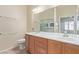 Bathroom with double vanity and large mirror with shower/tub combo at 2404 Garganey Ave, North Las Vegas, NV 89084