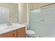 Well-lit bathroom featuring a shower with glass door and a granite countertop at 2404 Garganey Ave, North Las Vegas, NV 89084