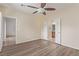 This bedroom features vinyl floors, a ceiling fan, and access to an attached bathroom and walk-in closet at 2404 Garganey Ave, North Las Vegas, NV 89084