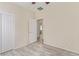 Empty bedroom featuring new vinyl flooring, a walk-in closet, and access to an attached bathroom at 2404 Garganey Ave, North Las Vegas, NV 89084