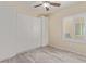 Bedroom with closet built-ins, window with blinds, vinyl flooring, and a ceiling fan at 2404 Garganey Ave, North Las Vegas, NV 89084