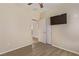 Bedroom with vinyl flooring, pre-installed TV mount and access to an attached bathroom at 2404 Garganey Ave, North Las Vegas, NV 89084