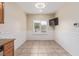 Bright dining area features a window, tiled floors, and white wainscoting at 2404 Garganey Ave, North Las Vegas, NV 89084