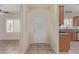 Welcoming foyer featuring tile flooring, a security door, and a view of the kitchen at 2404 Garganey Ave, North Las Vegas, NV 89084