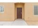 Close-up of the secure front entrance featuring a decorative security door and desert landscaping at 2404 Garganey Ave, North Las Vegas, NV 89084