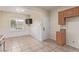 Open kitchen features a window, dining area, granite counters, and tiled floors at 2404 Garganey Ave, North Las Vegas, NV 89084