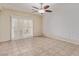 Bright living room features tile floors, a modern ceiling fan, and decorative textured walls at 2404 Garganey Ave, North Las Vegas, NV 89084