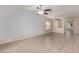 Bright, open-concept living room with tile floors, dual ceiling fans, and modern textured accent walls at 2404 Garganey Ave, North Las Vegas, NV 89084