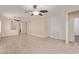 Bright, open-concept living room with tile floors, dual ceiling fans, and modern textured accent walls at 2404 Garganey Ave, North Las Vegas, NV 89084