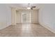 Spacious living room with tile floors, modern ceiling fan, and sliding door access to the backyard at 2404 Garganey Ave, North Las Vegas, NV 89084