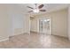 Bright living room features tile floors, a modern ceiling fan, and decorative textured walls at 2404 Garganey Ave, North Las Vegas, NV 89084